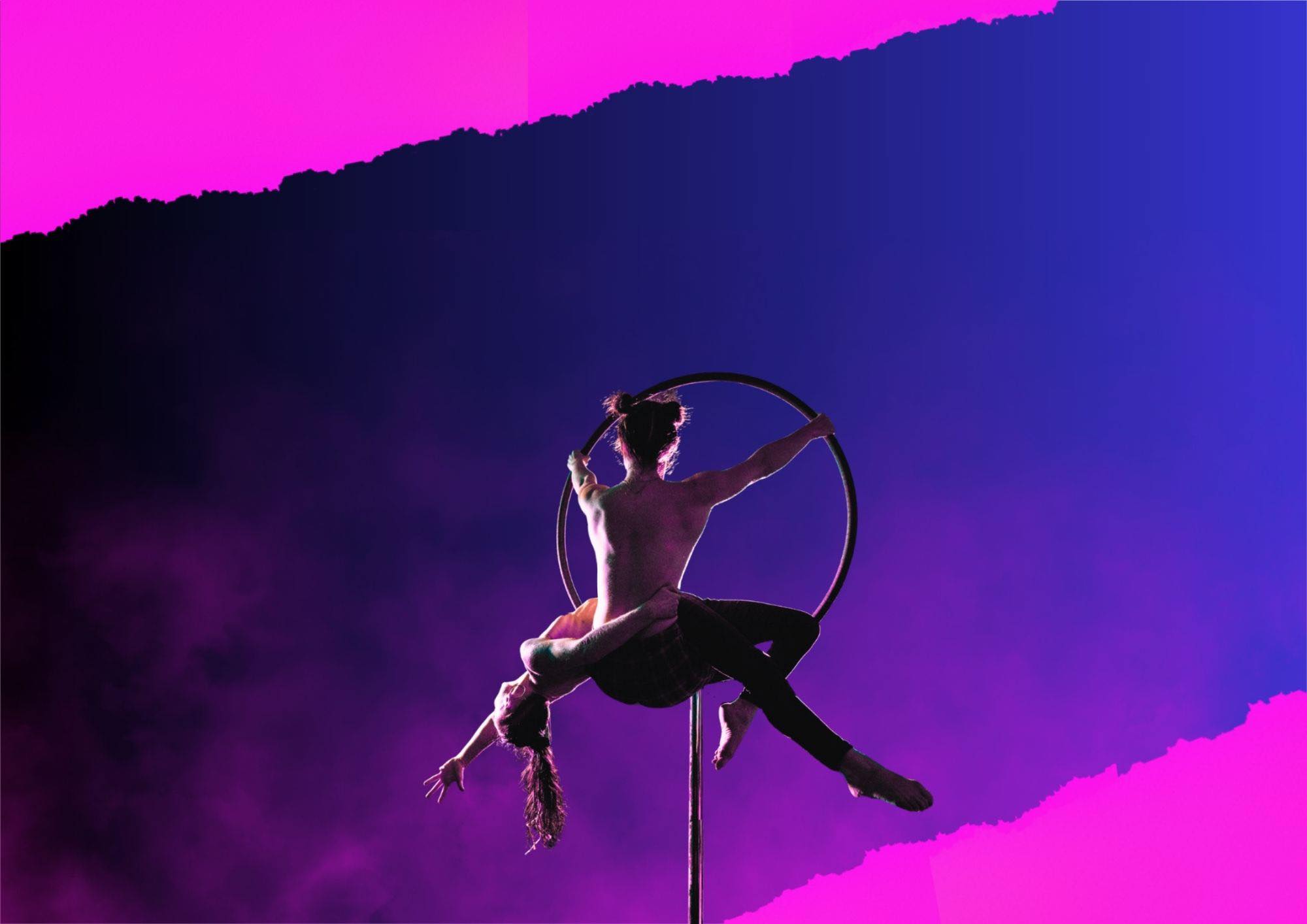 Circus ensemble production - multiple performers on neon-lit stage